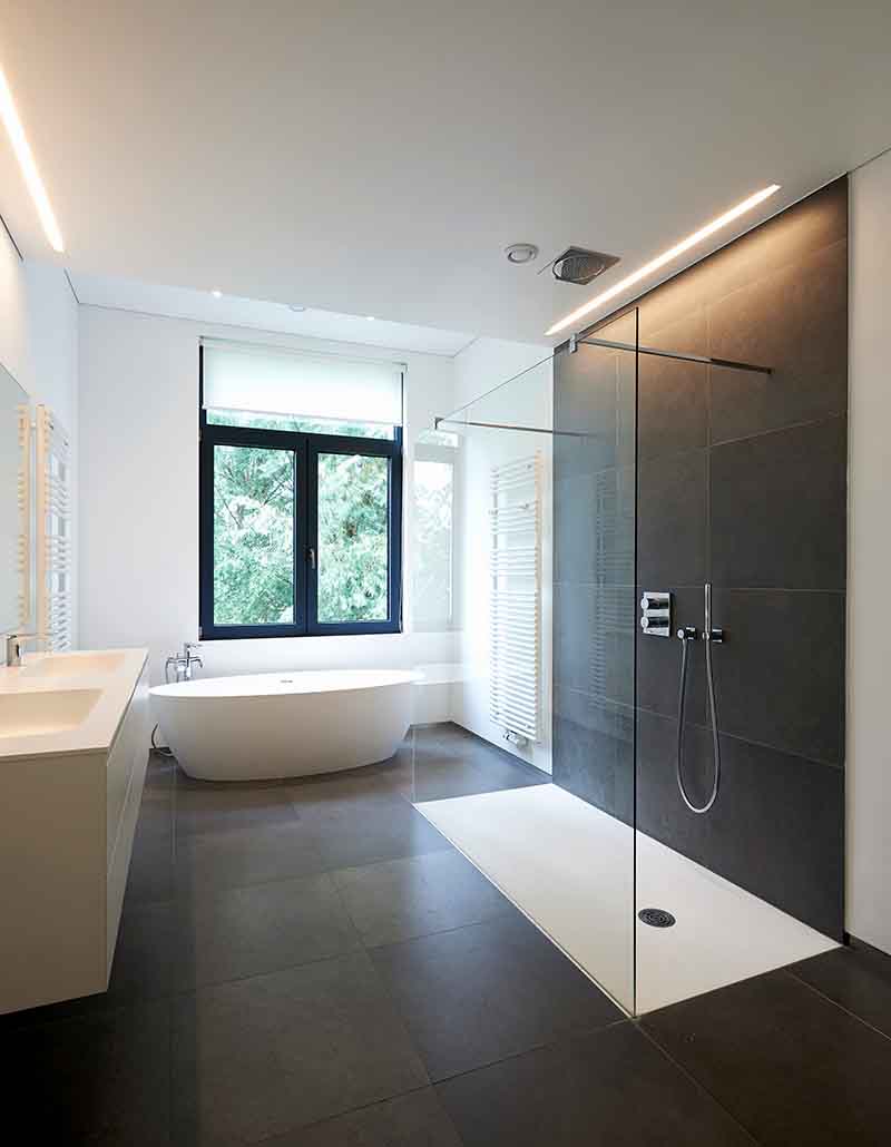 Modern bathroom with glass shower, freestanding bathtub, and sleek vanity installed by L.F. Fenimore Plumbing and HVAC in South New Jersey.