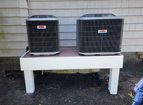 Dual outdoor HVAC condenser units installed on raised platform by L.F. Fenimore Plumbing & Heating in South Jersey.