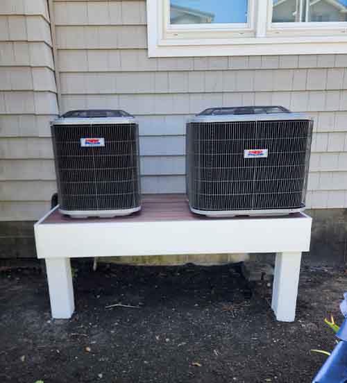 Dual outdoor HVAC condenser units installed on raised platform by L.F. Fenimore Plumbing & HVAC in South Jersey.