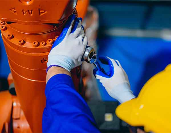 Technician performing industrial HVAC maintenance with wrench by L.F. Fenimore Plumbing and HVAC in South New Jersey.