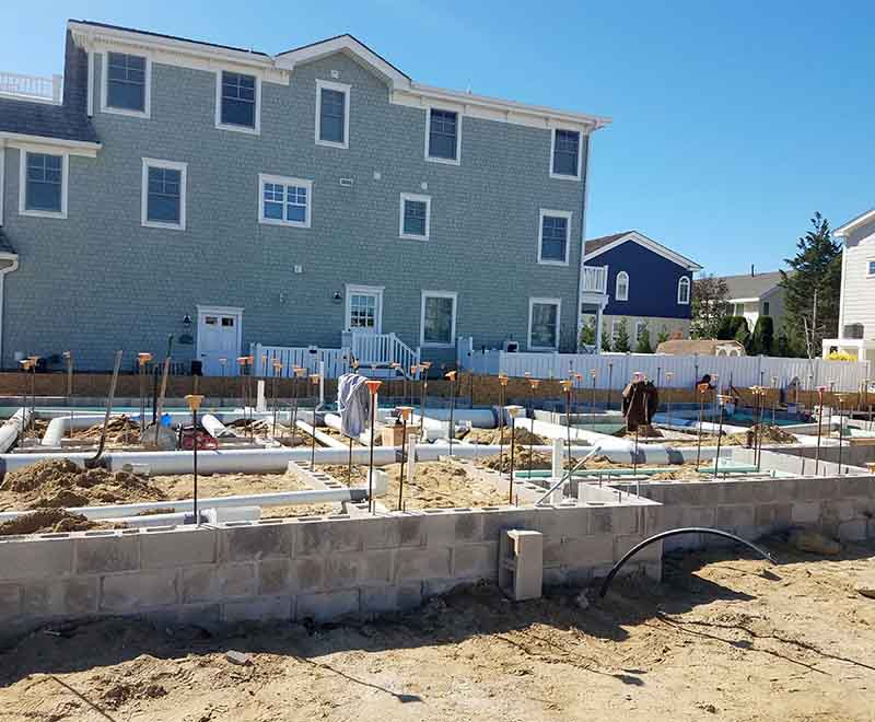 New construction plumbing rough-in installation at a residential foundation in Sea Isle City NJ by professional South Jersey plumbers.